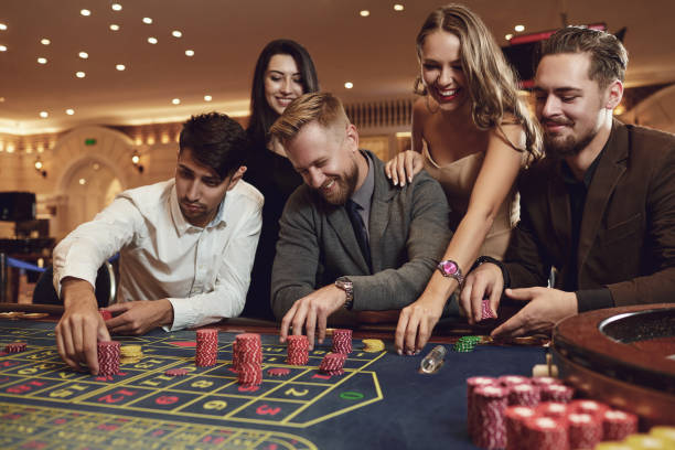 Group playing roulette at casino.